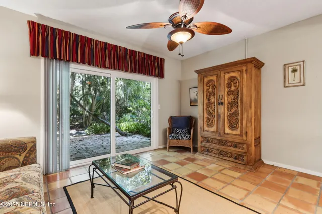 a bedroom with a bed a chandelier and a window