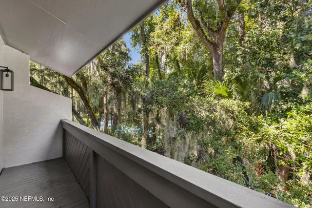 a view of a house with potted plants in front of door