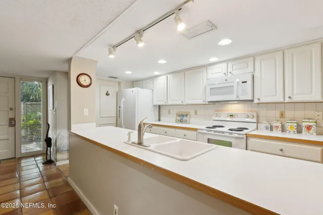 a spacious bathroom with a granite countertop sink a mirror and a shower
