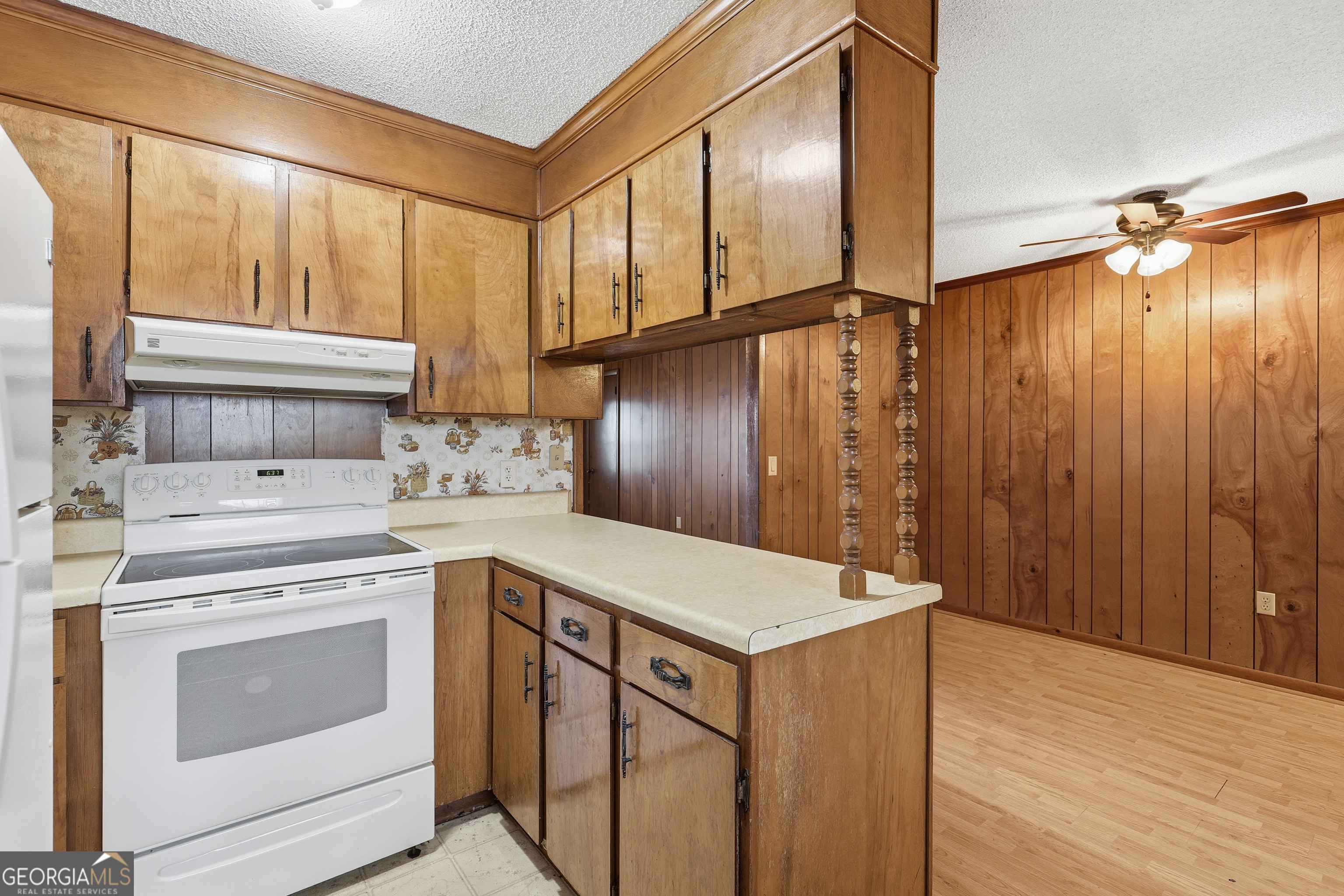 4 Forest Avenue Portal, GA 30450 - Photo 12 of 23 a kitchen that has a sink a stove and a wooden floor