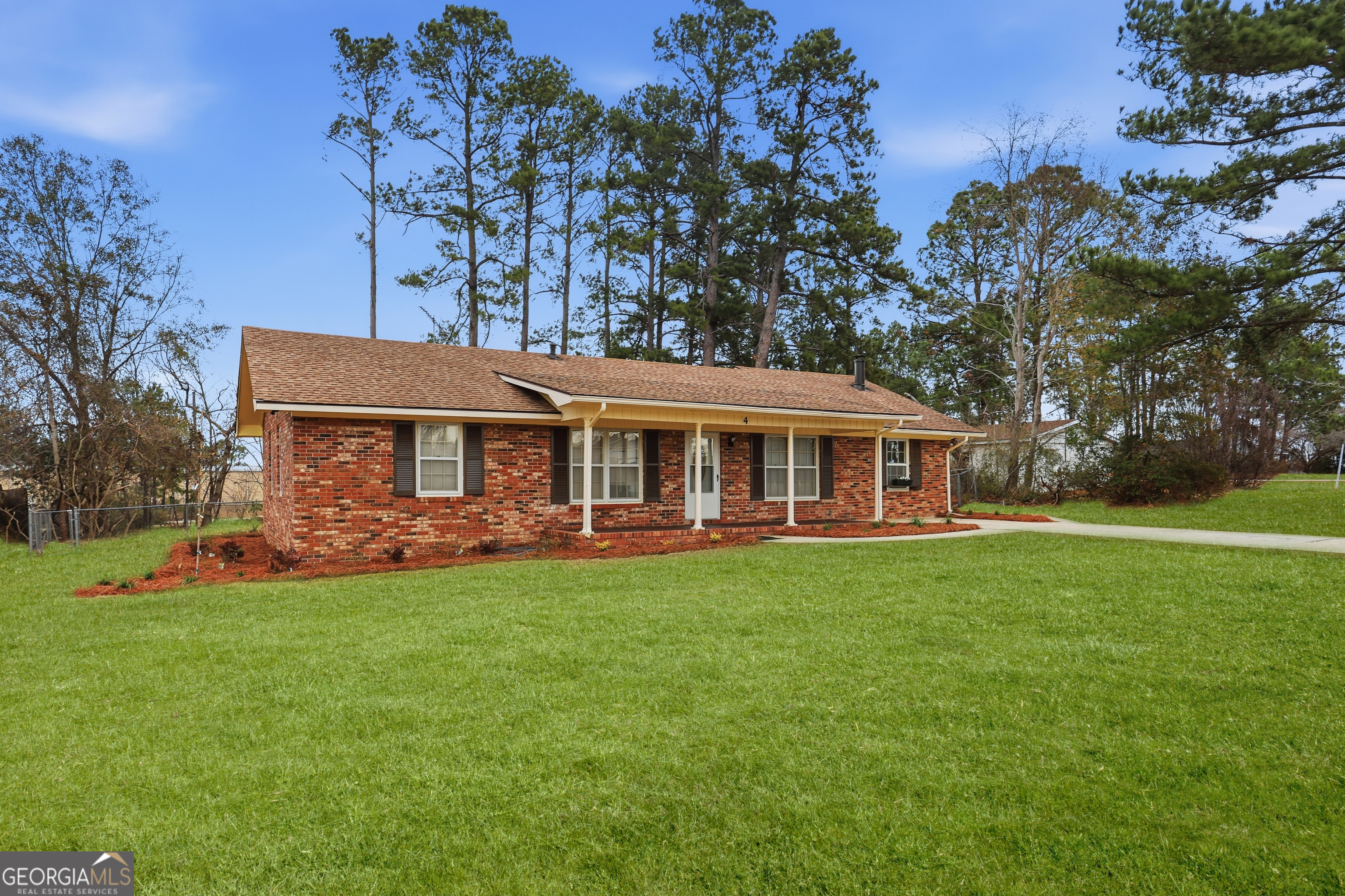 4 Forest Avenue Portal, GA 30450 - Photo 2 of 23 a front view of a house with a garden