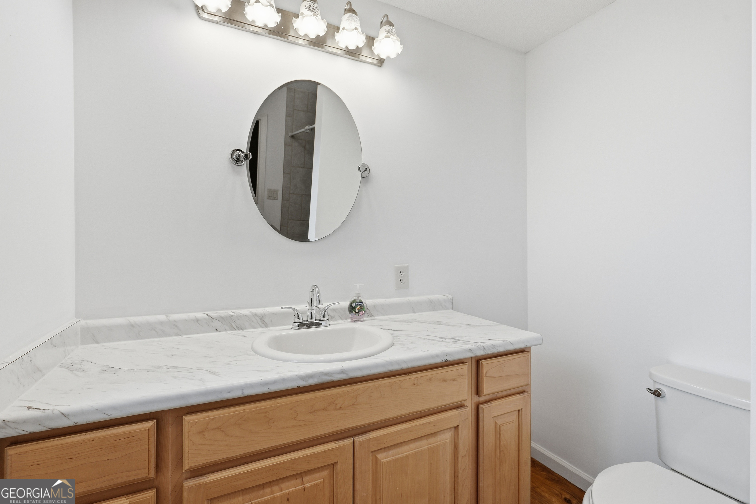 4 Forest Avenue Portal, GA 30450 - Photo 22 of 23 a bathroom with a sink a vanity and a mirror