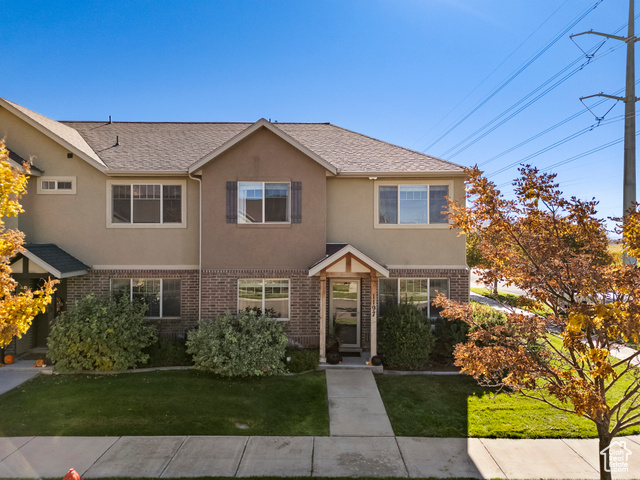 1197 West 150 South Springville, UT 84663 - Photo 1 of 1 Traditional-style house with brick siding, stucco siding, and a front lawn