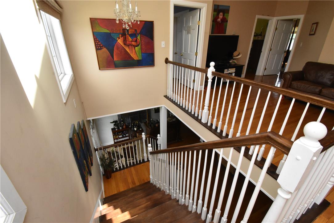 424 Grape Street Whitehall, PA 18052 - Photo 24 of 50 This spacious interior features a grand wooden staircase with elegant white railings, connecting multiple levels.