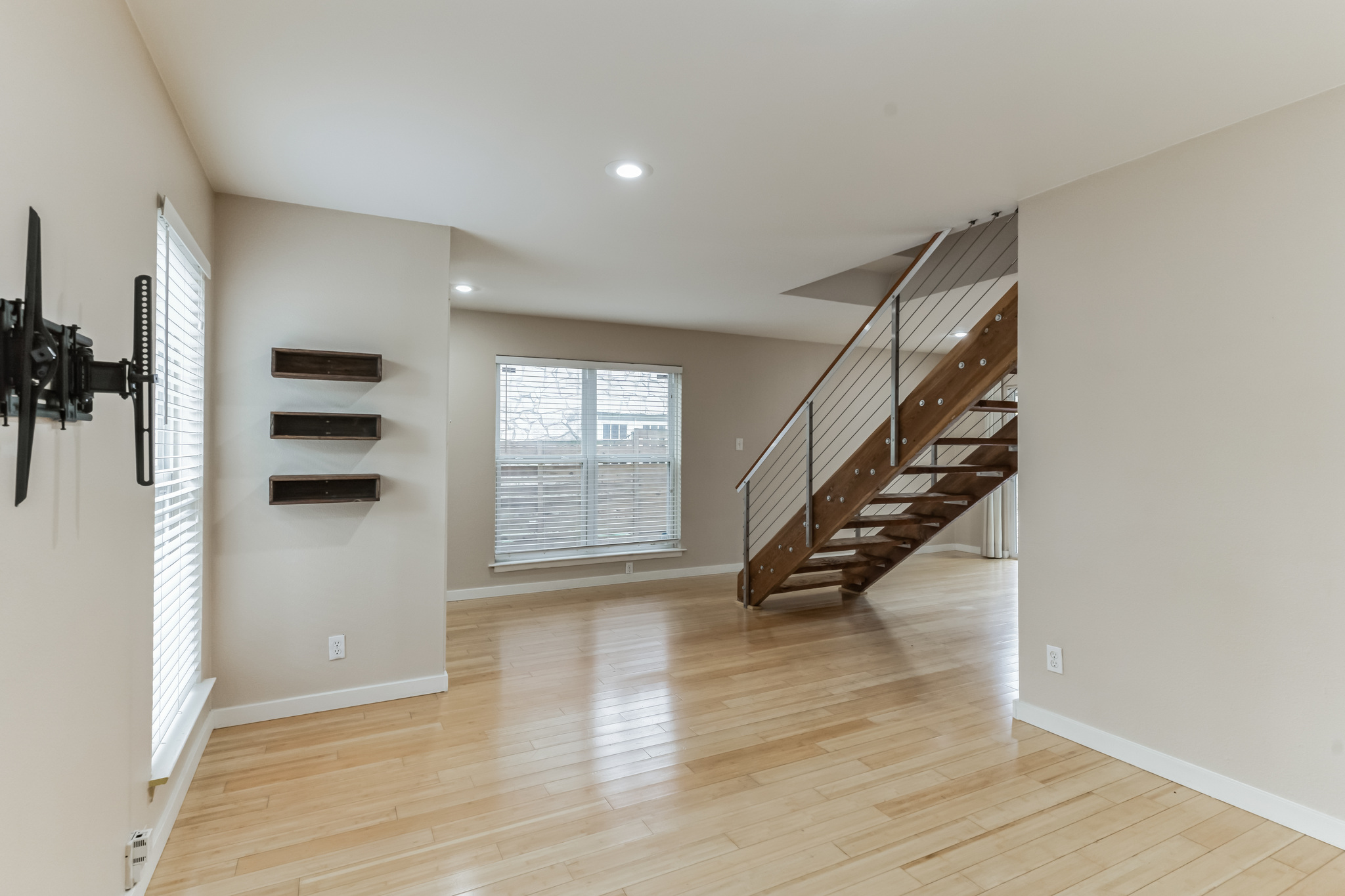 3214 Clawson Road, Unit A Austin, TX 78704 - Photo 4 of 26 Luminous hardwood flooring guides you through this inviting living space toward a modern staircase.