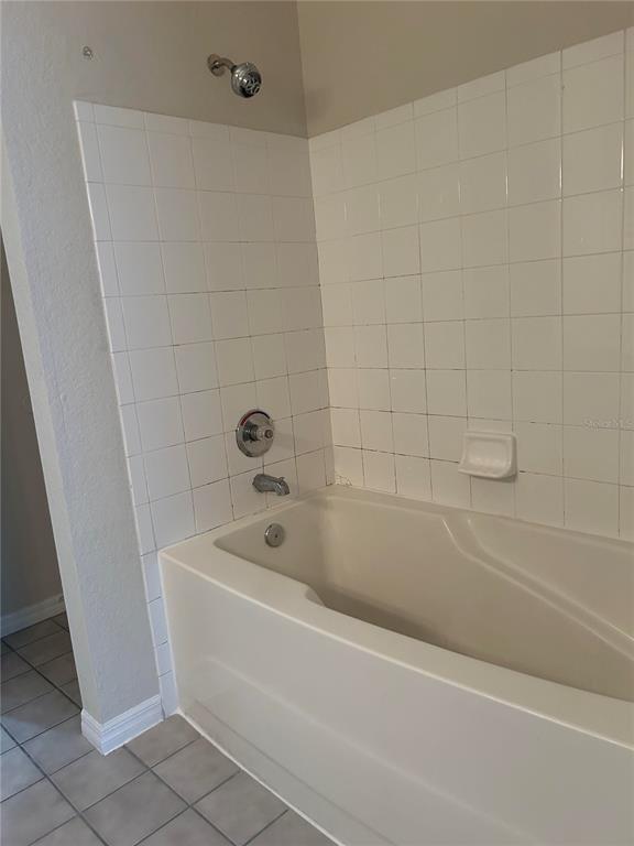 6308 Raleigh Street, Unit 303 Orlando, FL 32835 - Photo 11 of 14 a bathroom with a bathtub