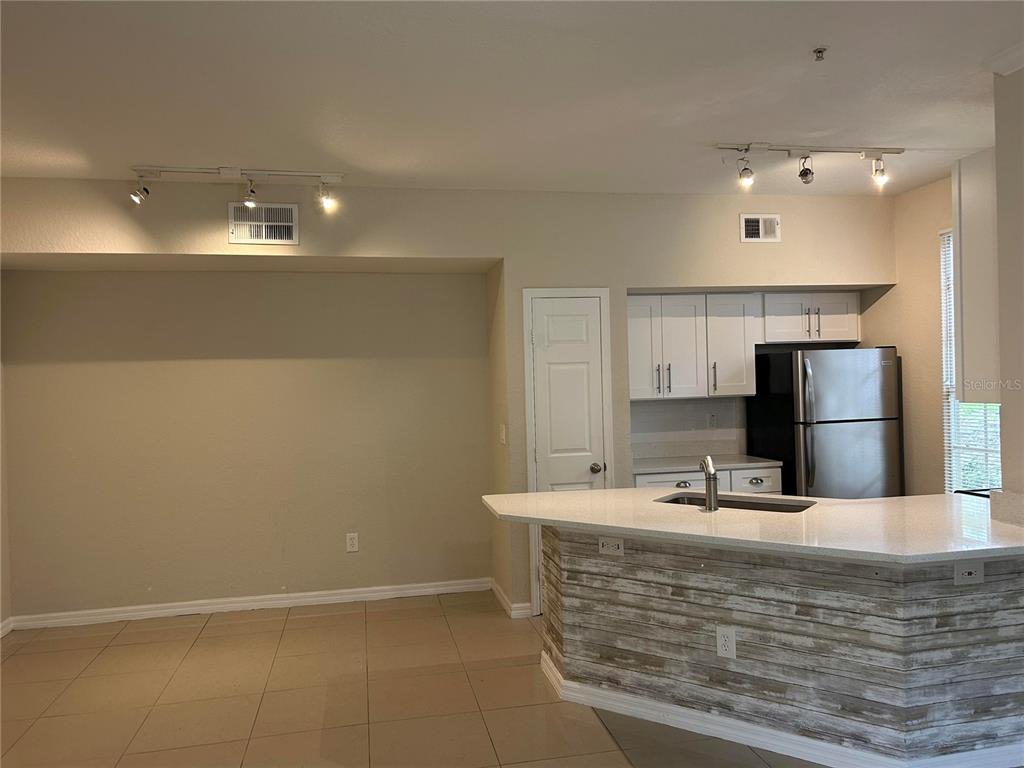 6308 Raleigh Street, Unit 303 Orlando, FL 32835 - Photo 3 of 14 a bathroom with a sink a large mirror and a shower
