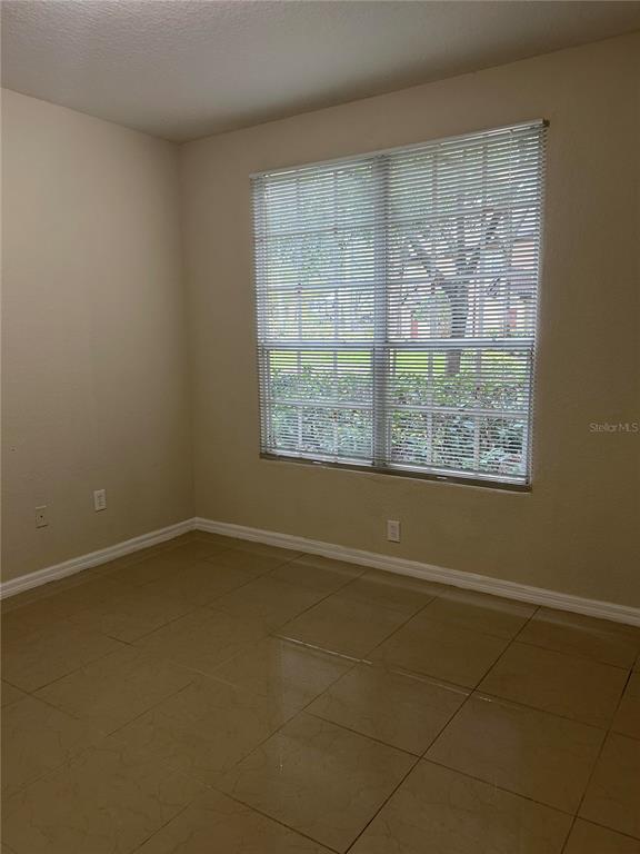 6308 Raleigh Street, Unit 303 Orlando, FL 32835 - Photo 6 of 14 an empty room with a window