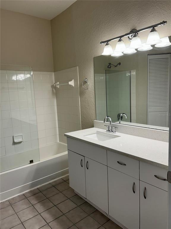 6308 Raleigh Street, Unit 303 Orlando, FL 32835 - Photo 7 of 14 a bathroom with a sink double vanity and a mirror