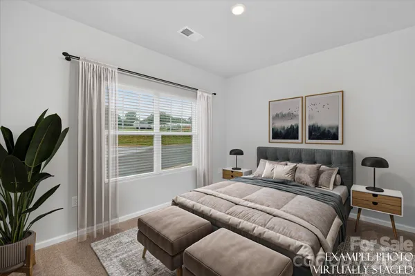 a bedroom with furniture and a window
