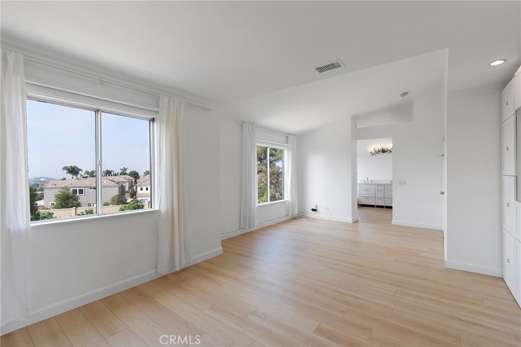 22 Carriage Drive Lake Forest, CA 92610 - Photo 14 of 35 a view of an empty room with wooden floor and a window