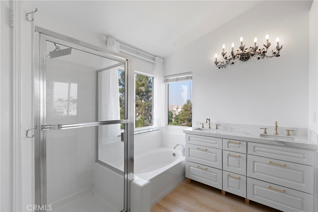22 Carriage Drive Lake Forest, CA 92610 - Photo 15 of 35 a spacious bathroom with a double vanity sink a large mirror a bathtub and window