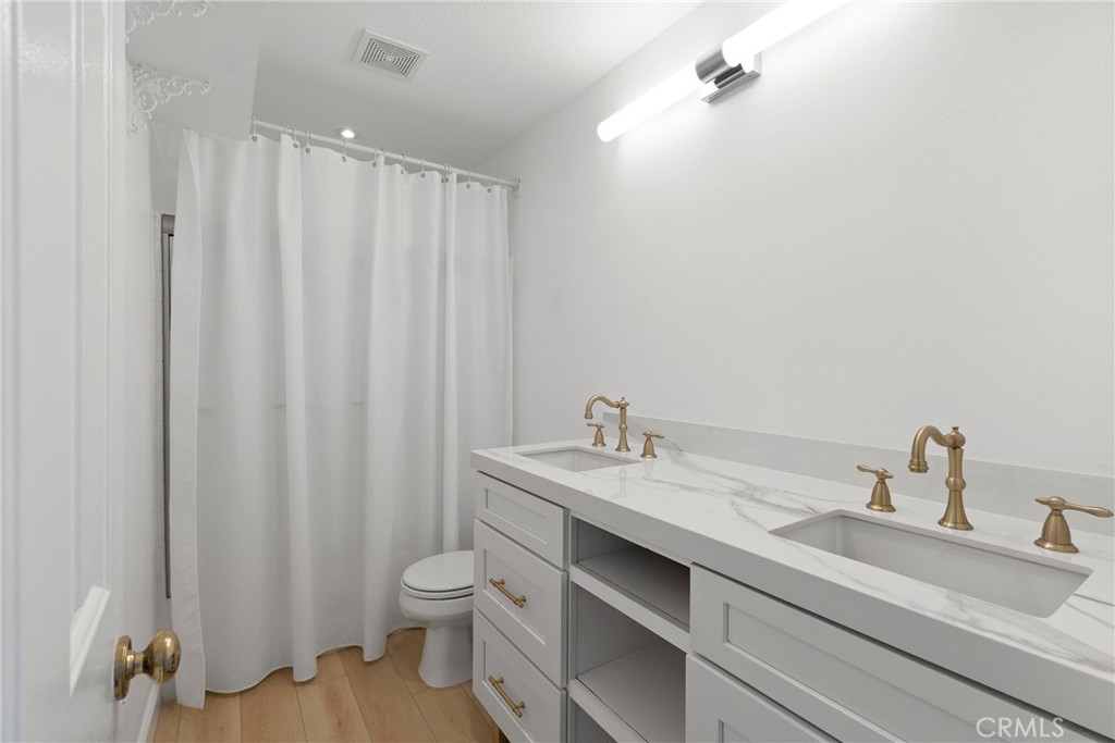 22 Carriage Drive Lake Forest, CA 92610 - Photo 21 of 35 a bathroom with a granite countertop sink and a mirror