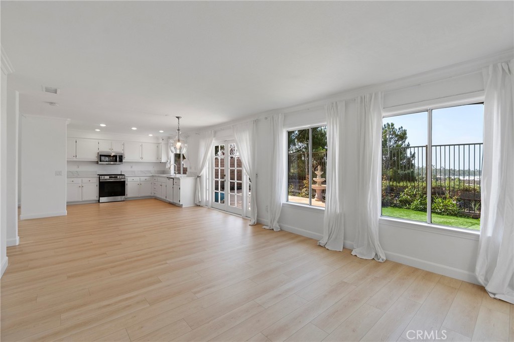 22 Carriage Drive Lake Forest, CA 92610 - Photo 10 of 35 a view of an empty room with a window and wooden floor