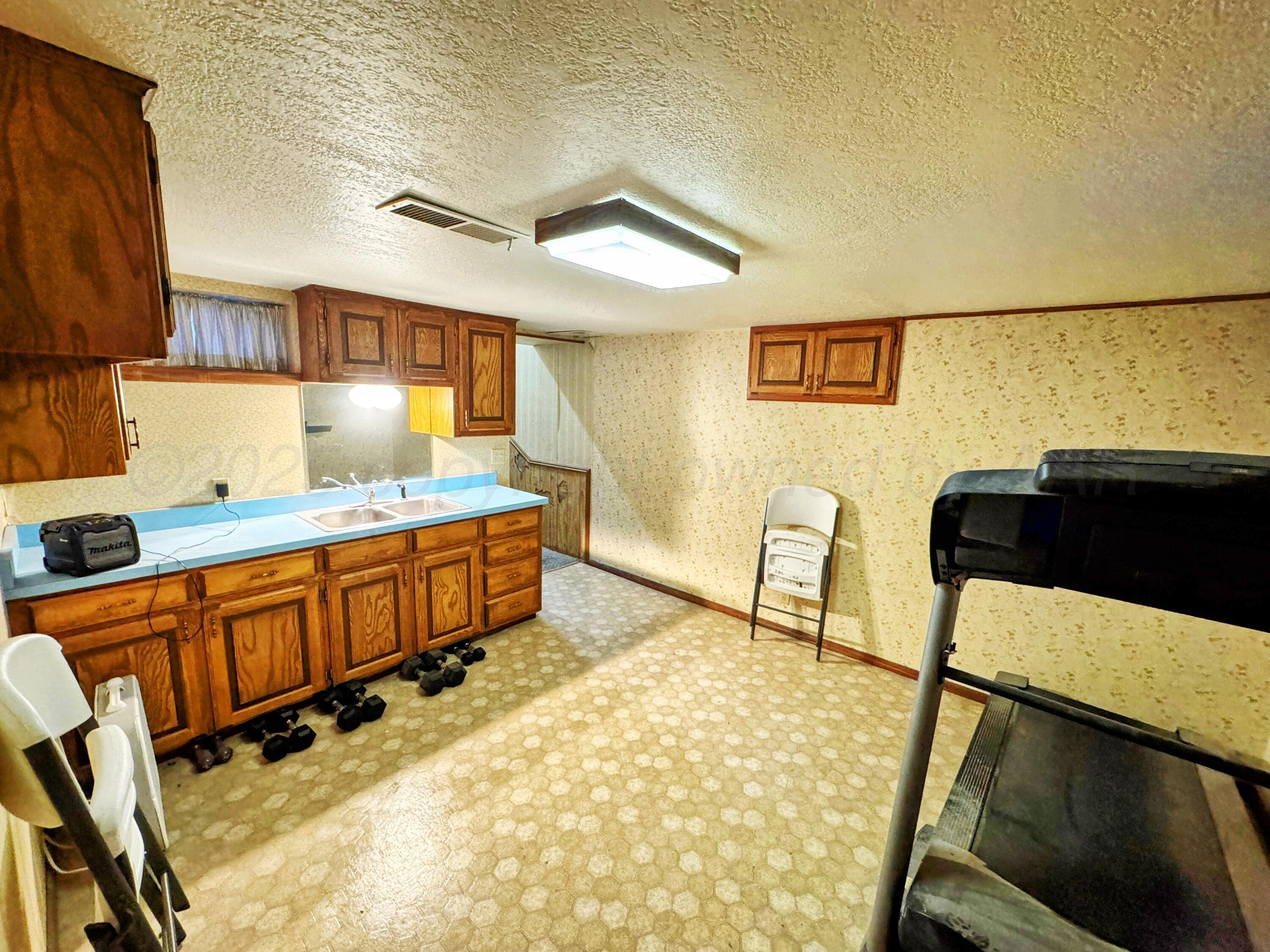14490 County Road 24 Perryton, TX 79070 - Photo 13 of 28 a view of a kitchen with a sink and cabinets