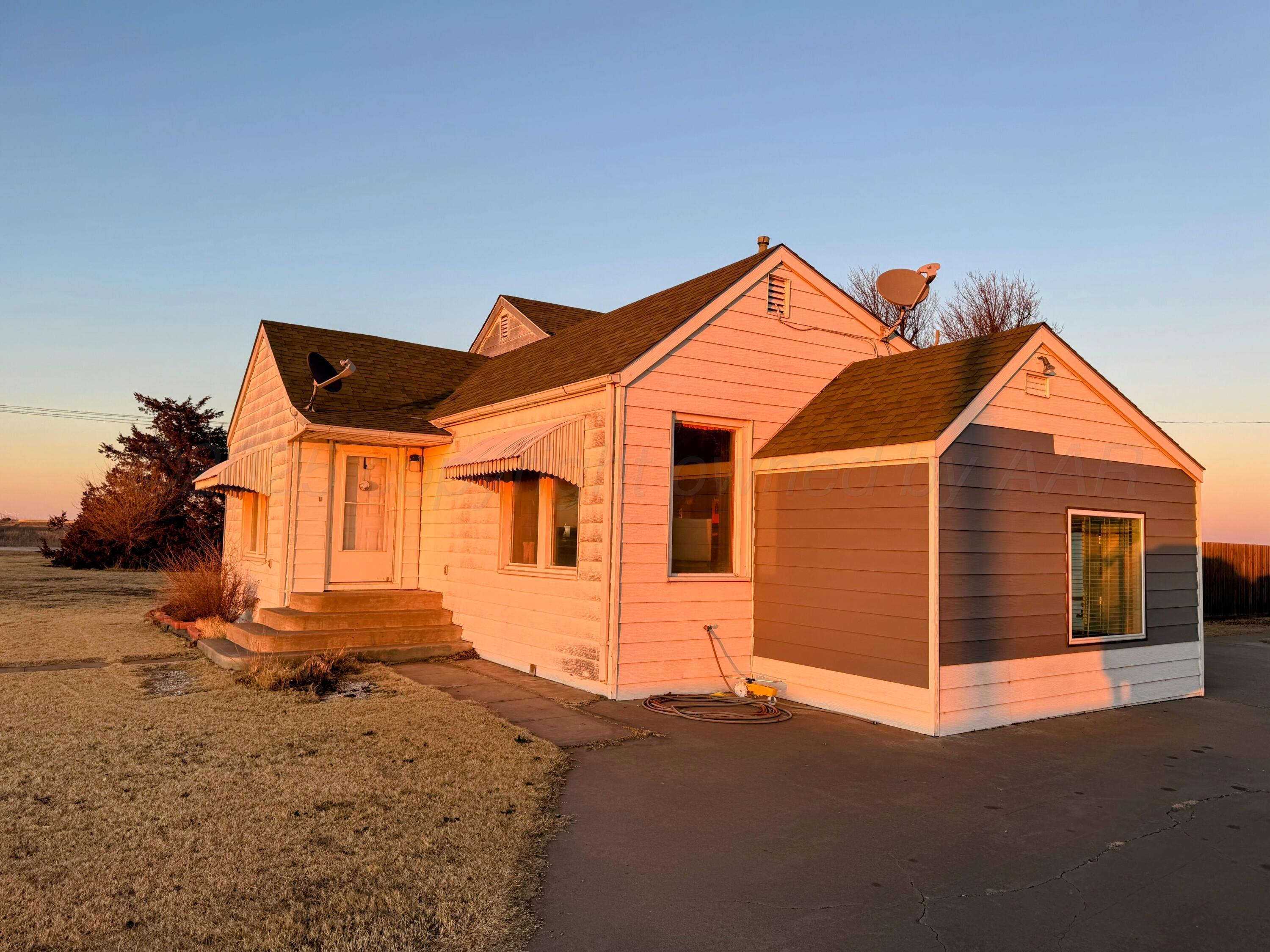 14490 County Road 24 Perryton, TX 79070 - Photo 2 of 28 a front view of a house with a yard