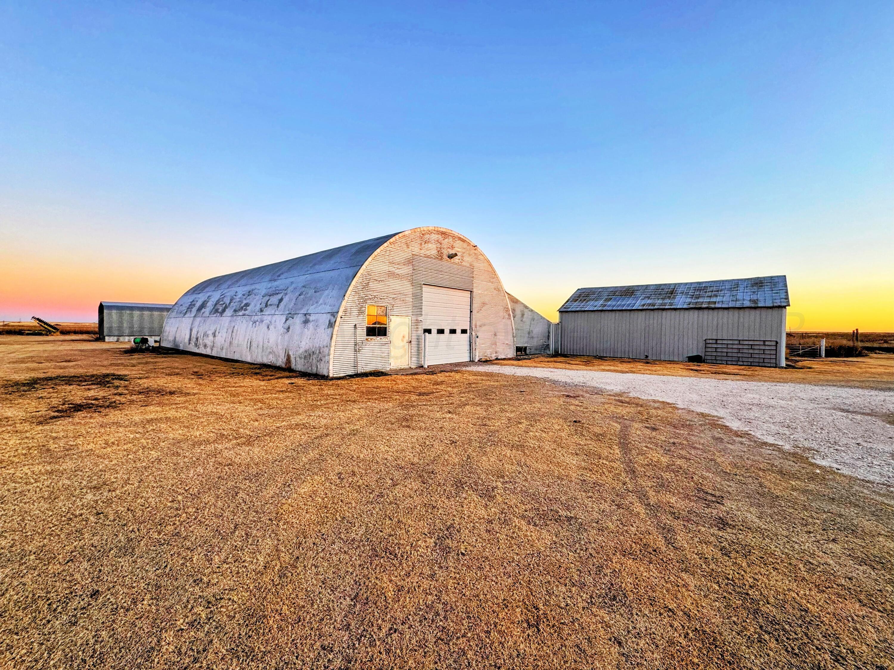 14490 County Road 24 Perryton, TX 79070 - Photo 23 of 28 a view of a bedroom with a bed and lamp
