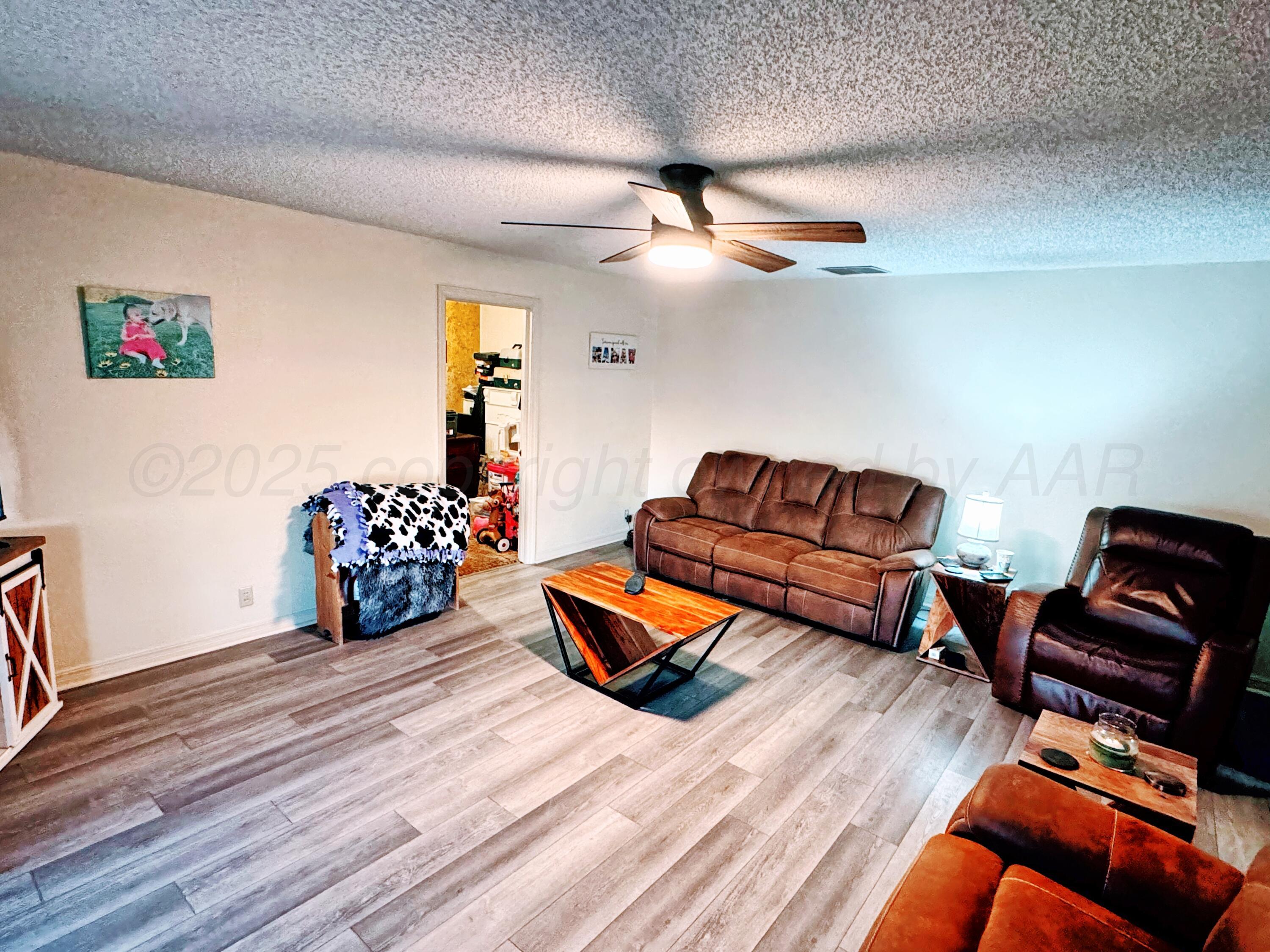 14490 County Road 24 Perryton, TX 79070 - Photo 3 of 28 a bedroom with furniture and wooden floor