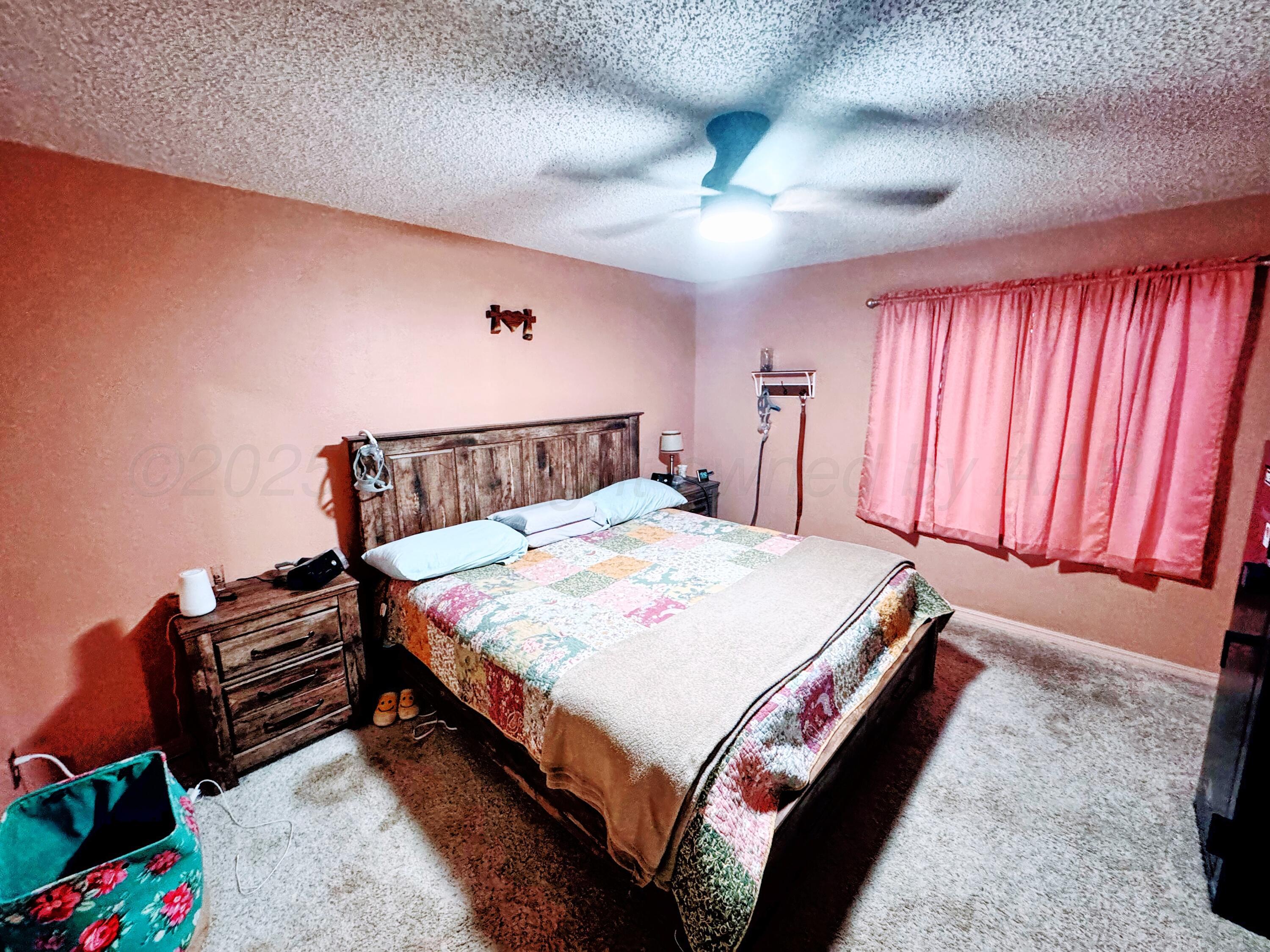 14490 County Road 24 Perryton, TX 79070 - Photo 8 of 28 a bedroom with bed and window