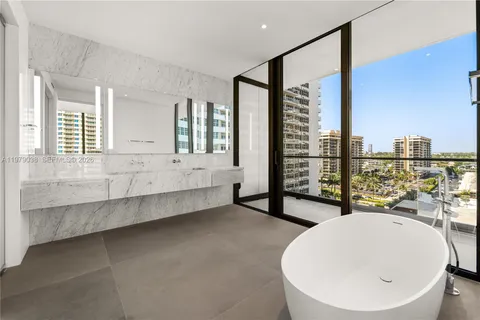 a large spacious bathroom with a tub shower and mirror
