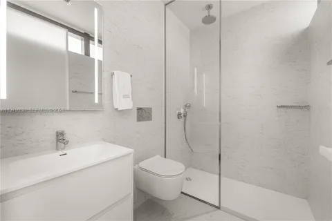 a large bed sitting in a bedroom next to a window