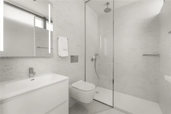 a large bed sitting in a bedroom next to a window