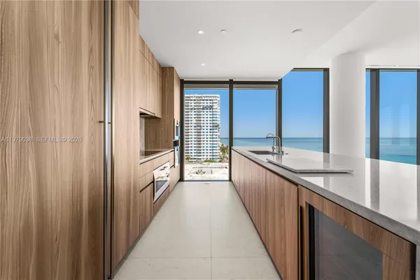 a large white kitchen with a large window