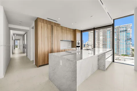 a large bed sitting in a bedroom next to a window
