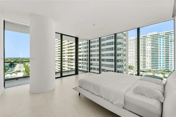 a bedroom with a bed and large window