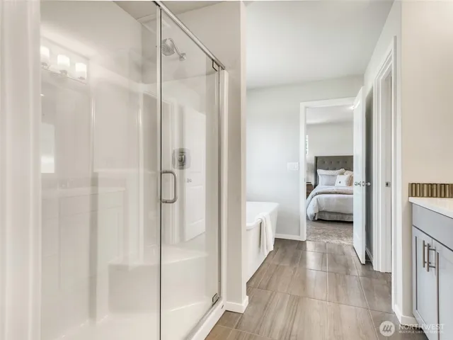 a en suite bathroom with a glass shower door