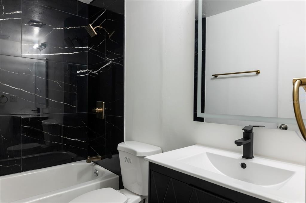 1031 Southwest 61st Street Gainesville, FL 32607 - Photo 12 of 17 a bathroom with a sink toilet and shower
