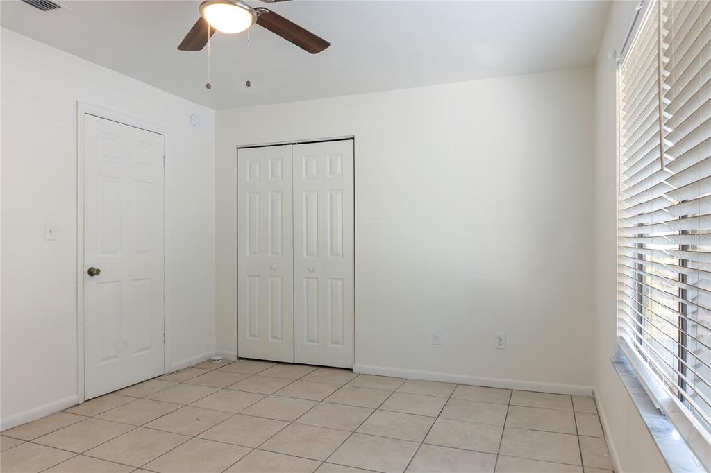 1031 Southwest 61st Street Gainesville, FL 32607 - Photo 13 of 17 an empty room with chandelier fan