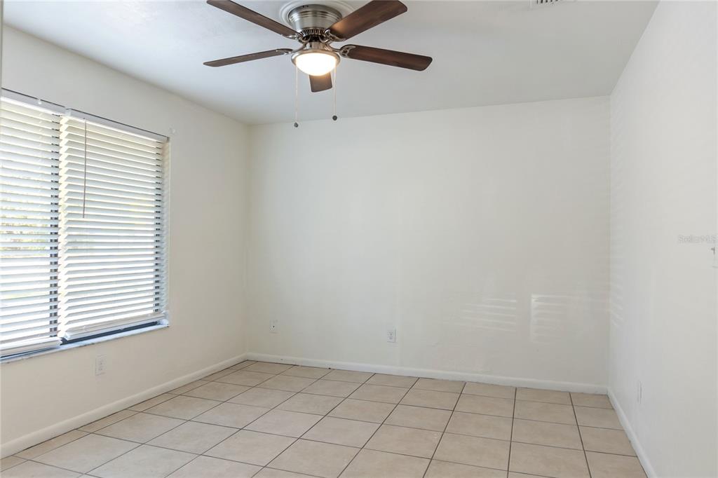 1031 Southwest 61st Street Gainesville, FL 32607 - Photo 14 of 17 an empty room with a window and a fan