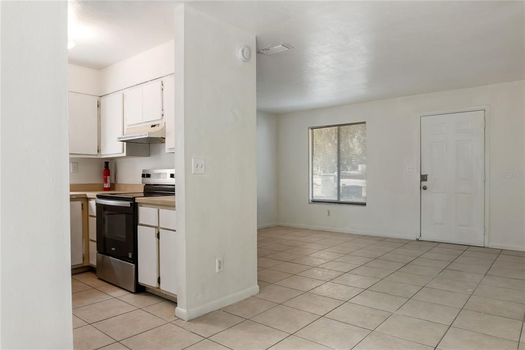 1031 Southwest 61st Street Gainesville, FL 32607 - Photo 7 of 17 a kitchen with white cabinets and appliances