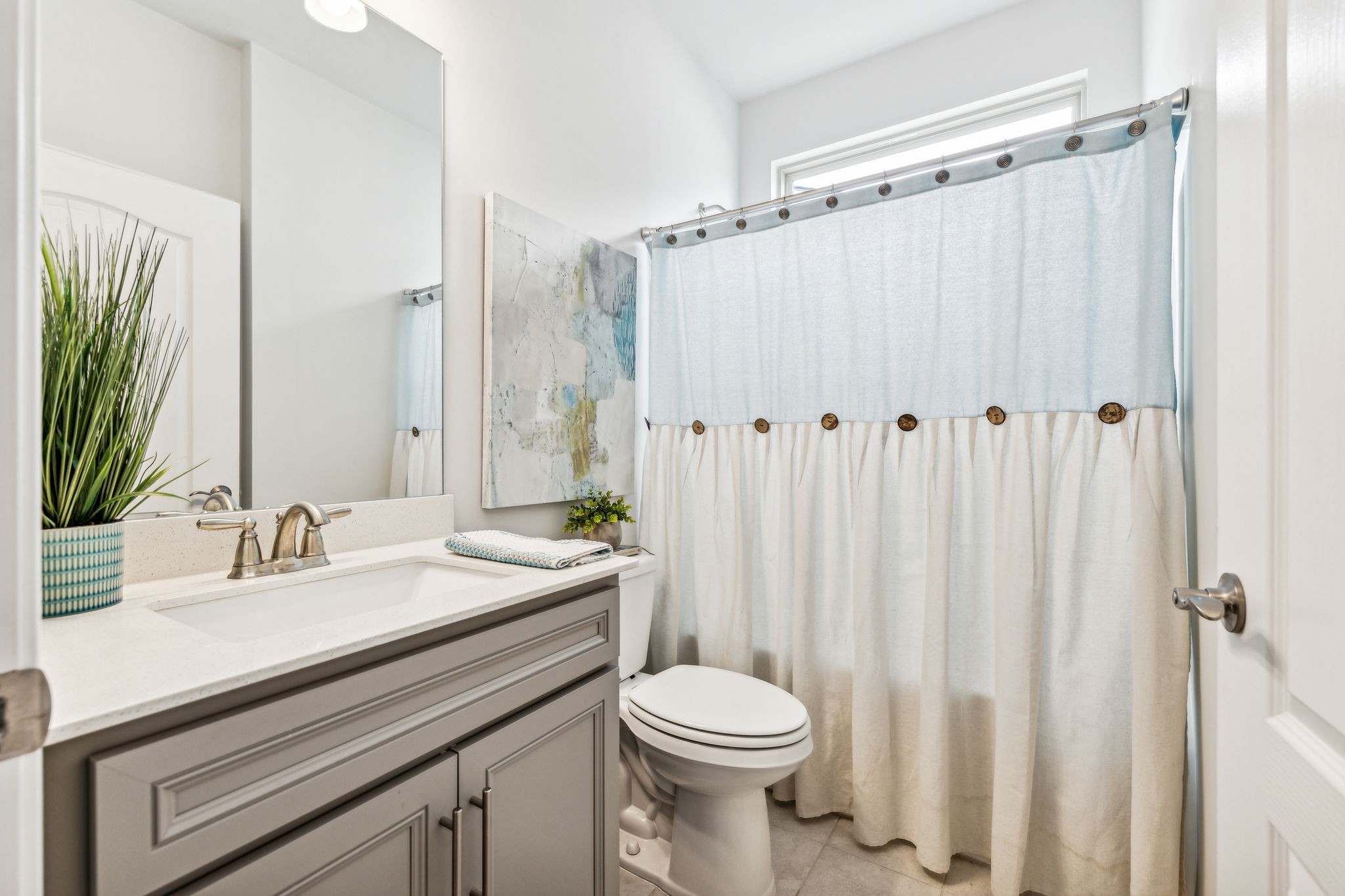1062 Sumner Grove Spring Hill, TN 37174 - Photo 28 of 44 a bathroom with a sink a toilet a mirror and shower curtain