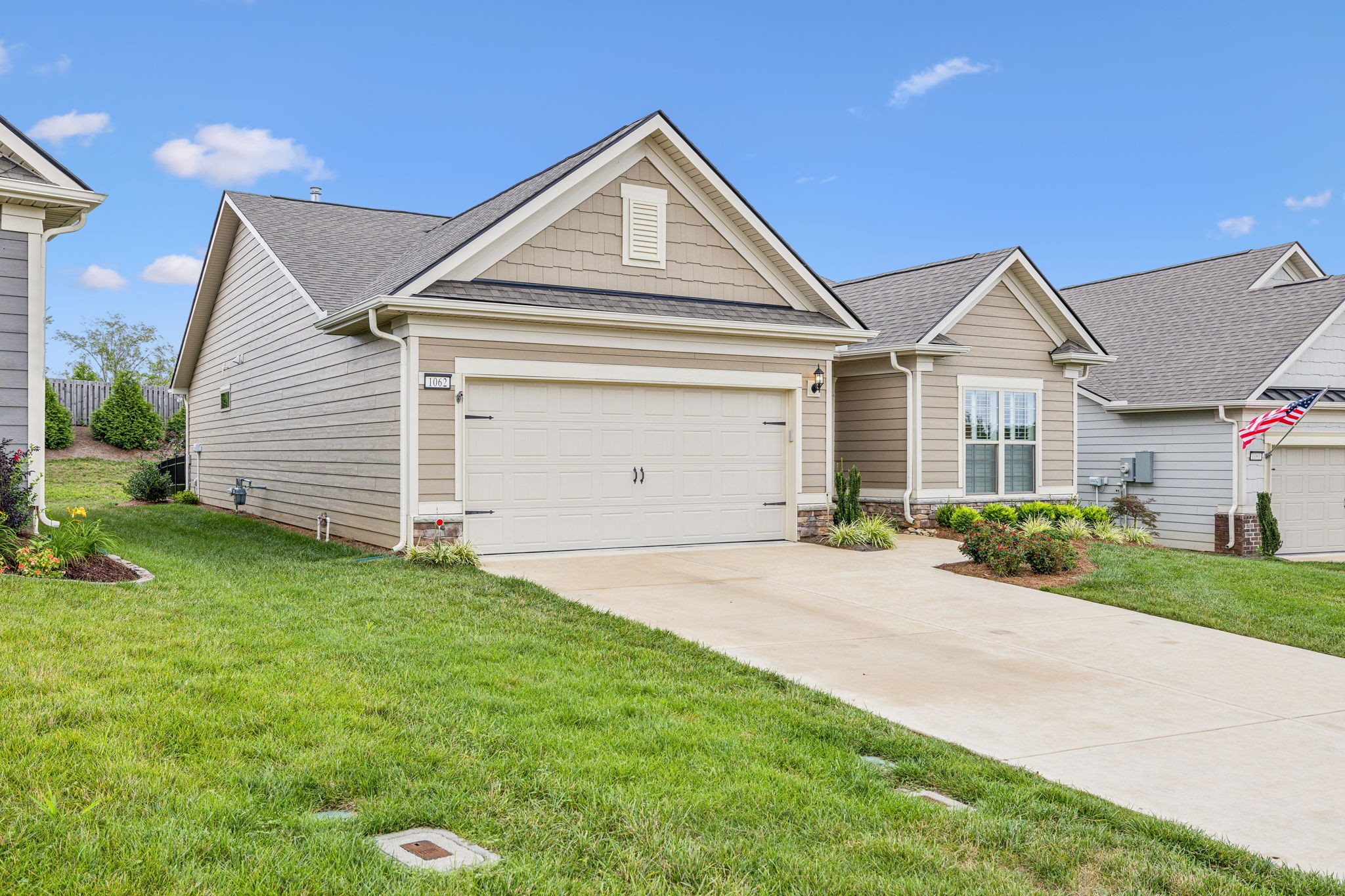 1062 Sumner Grove Spring Hill, TN 37174 - Photo 3 of 44 a front view of a house with a yard and garage