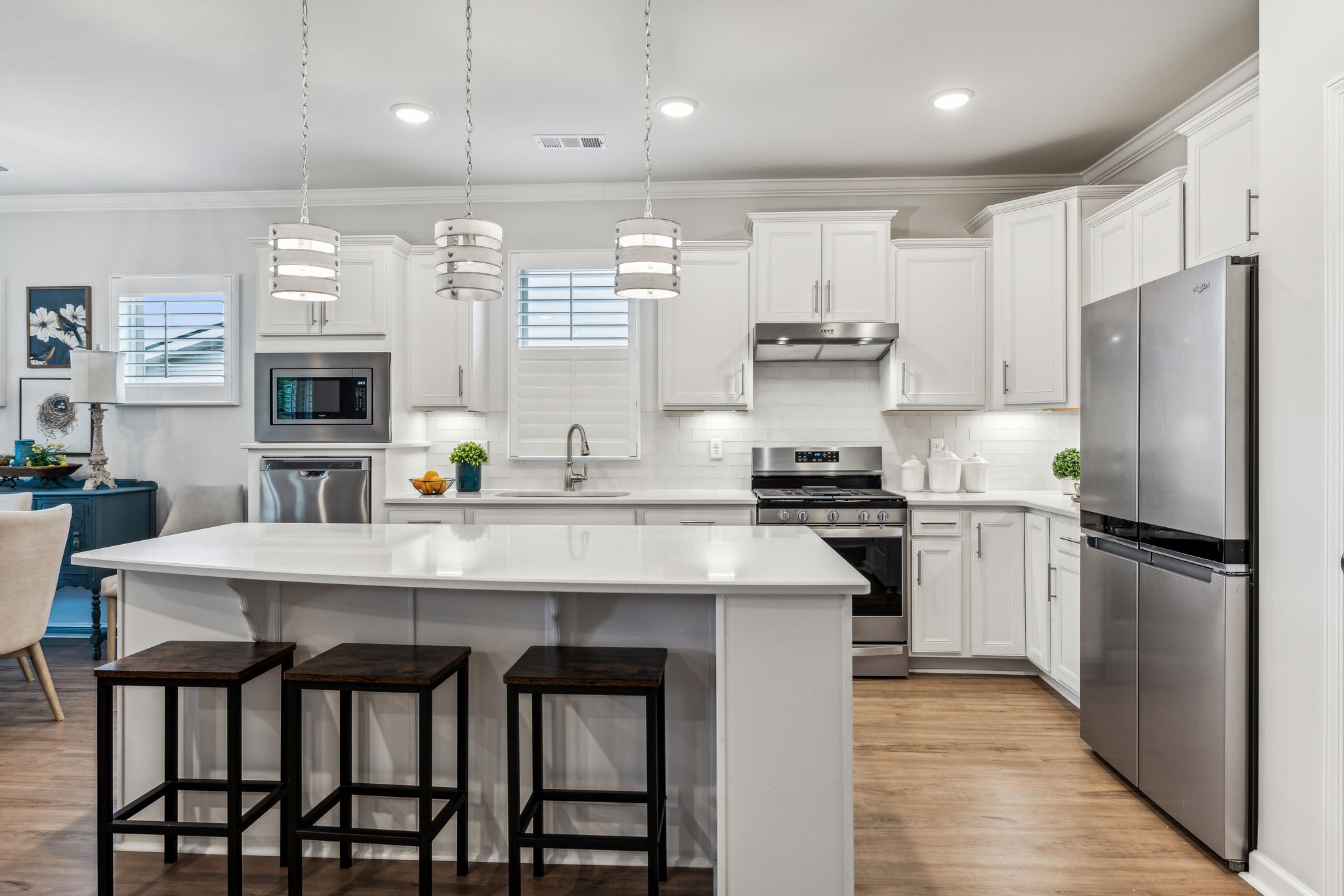 1062 Sumner Grove Spring Hill, TN 37174 - Photo 9 of 44 a kitchen with refrigerator a stove and chairs