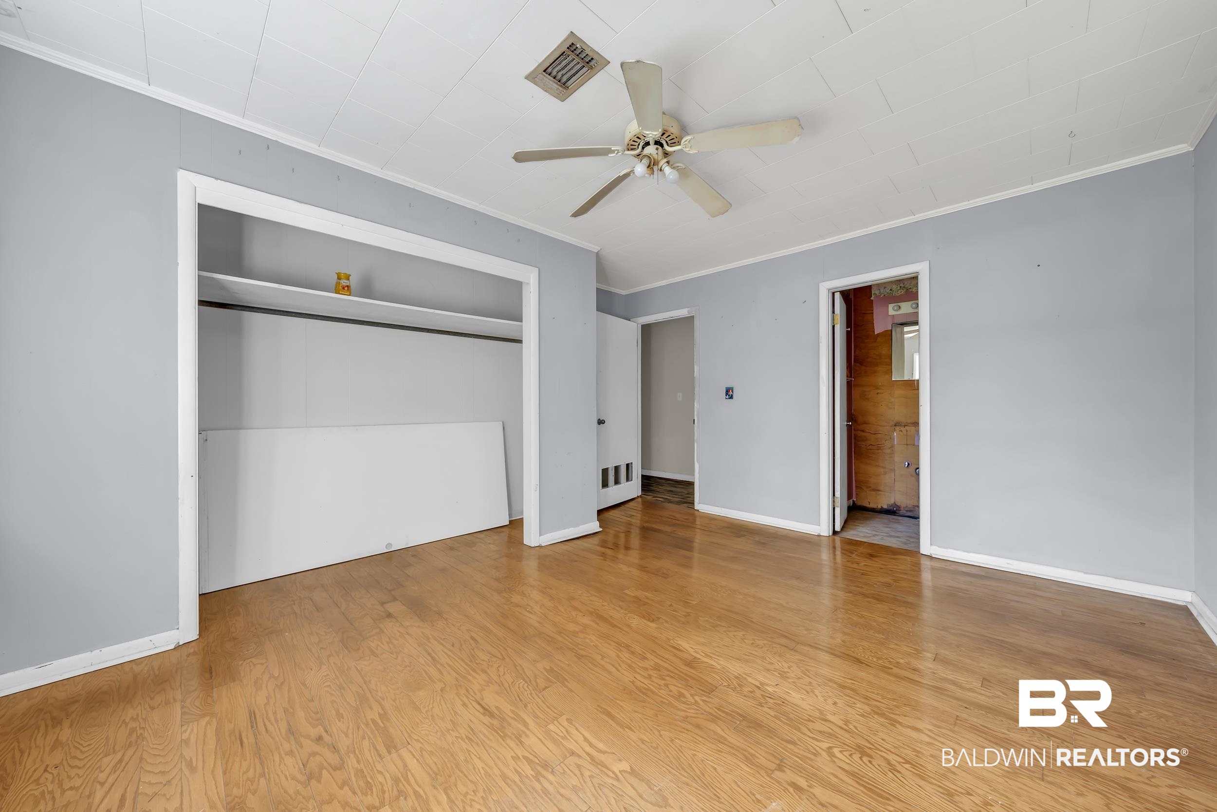 17463 Highway 98 Foley, AL 36535 - Photo 17 of 57 Unfurnished bedroom with ornamental molding, ceiling fan, light wood finished floors, a closet, and ensuite bath