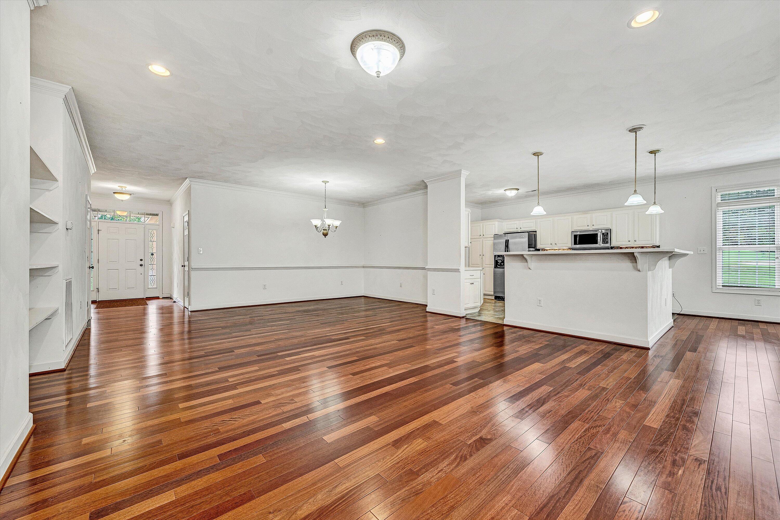 1613 Edgebrook Road Salem, VA 24153 - Photo 5 of 40 an empty room with wooden floor and kitchen view