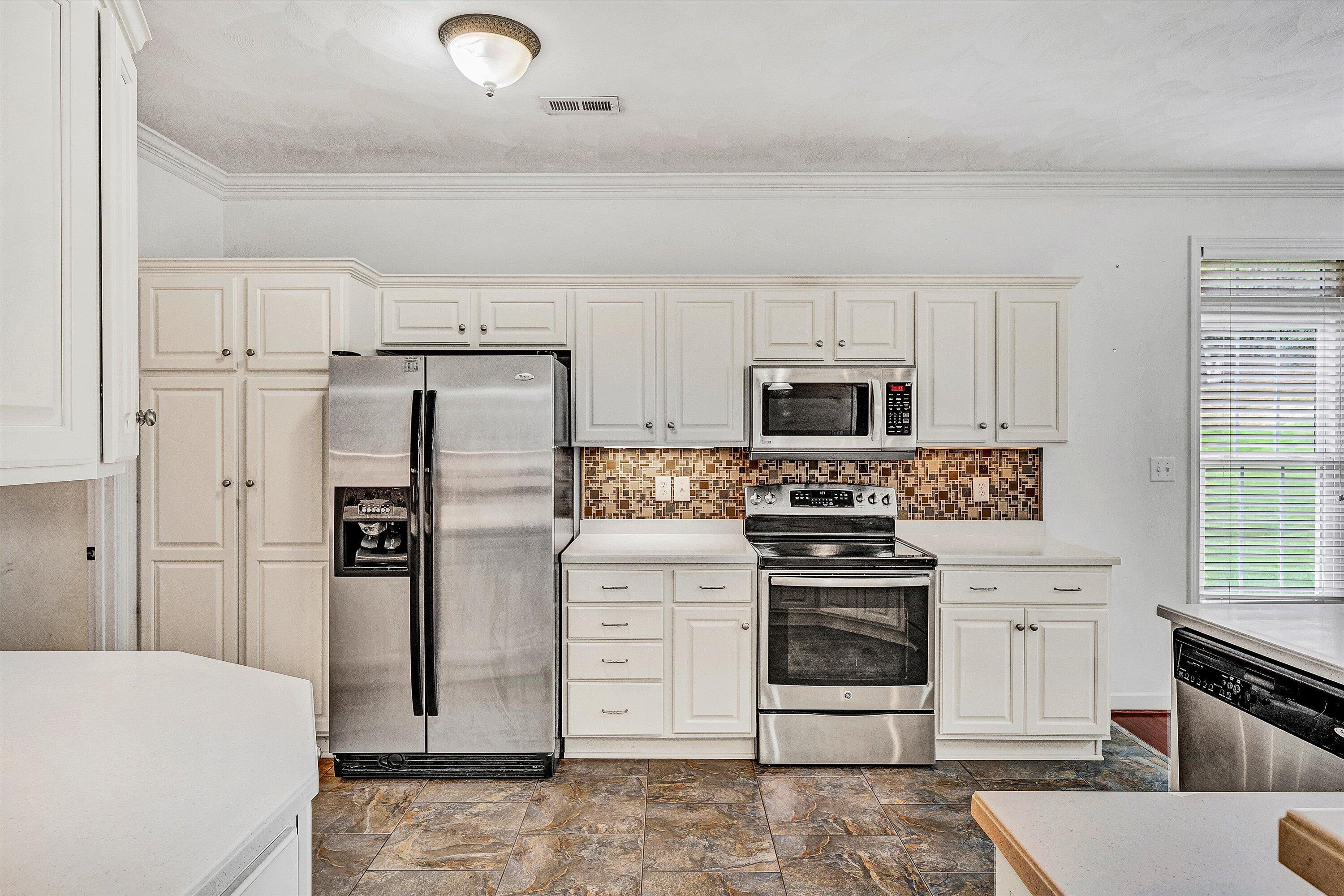 1613 Edgebrook Road Salem, VA 24153 - Photo 8 of 40 a kitchen with stainless steel appliances white cabinets and a stove top oven