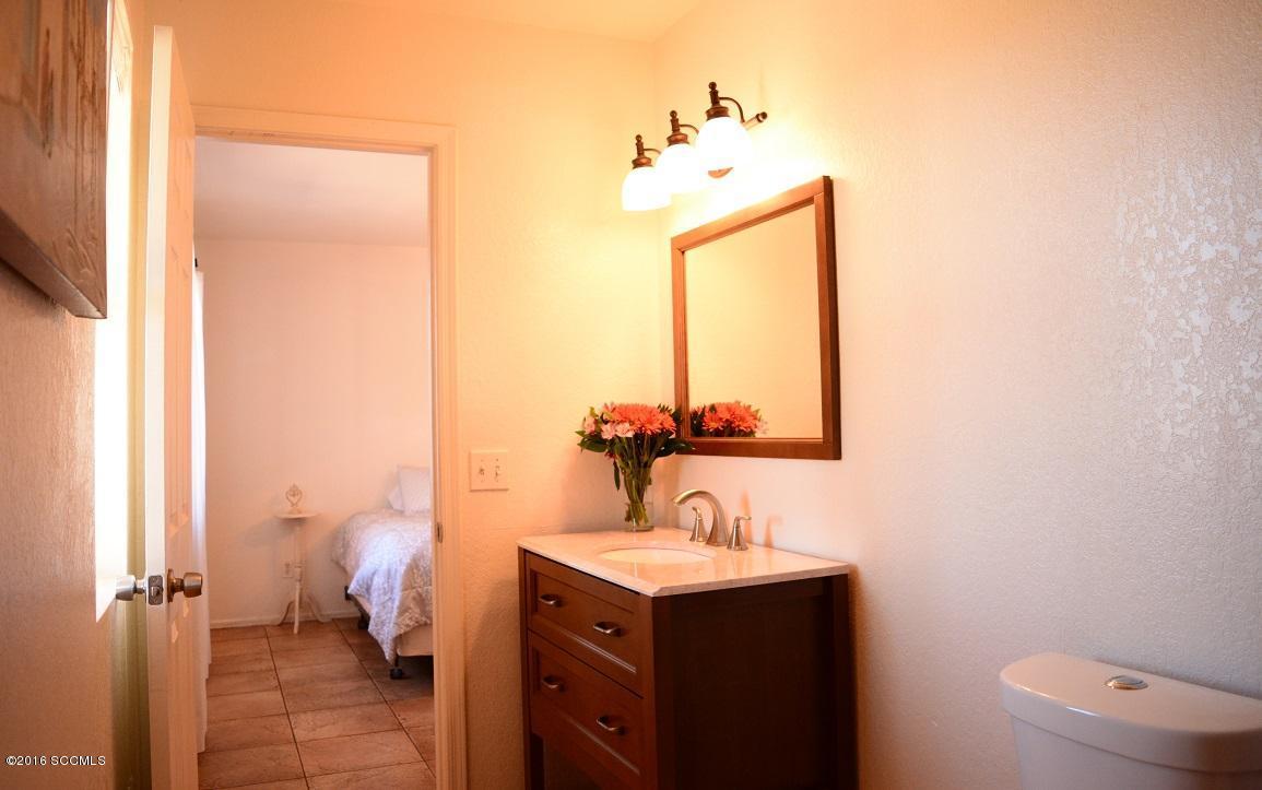 1032 Via Independencia Rio Rico, AZ 85648 - Photo 13 of 22 a bathroom with a sink vanity mirror and toilet