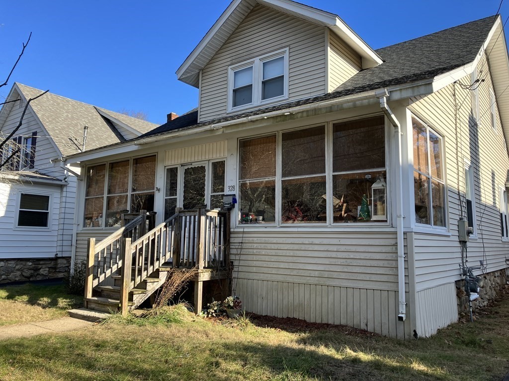 a view of a house with a yard and wooden fence