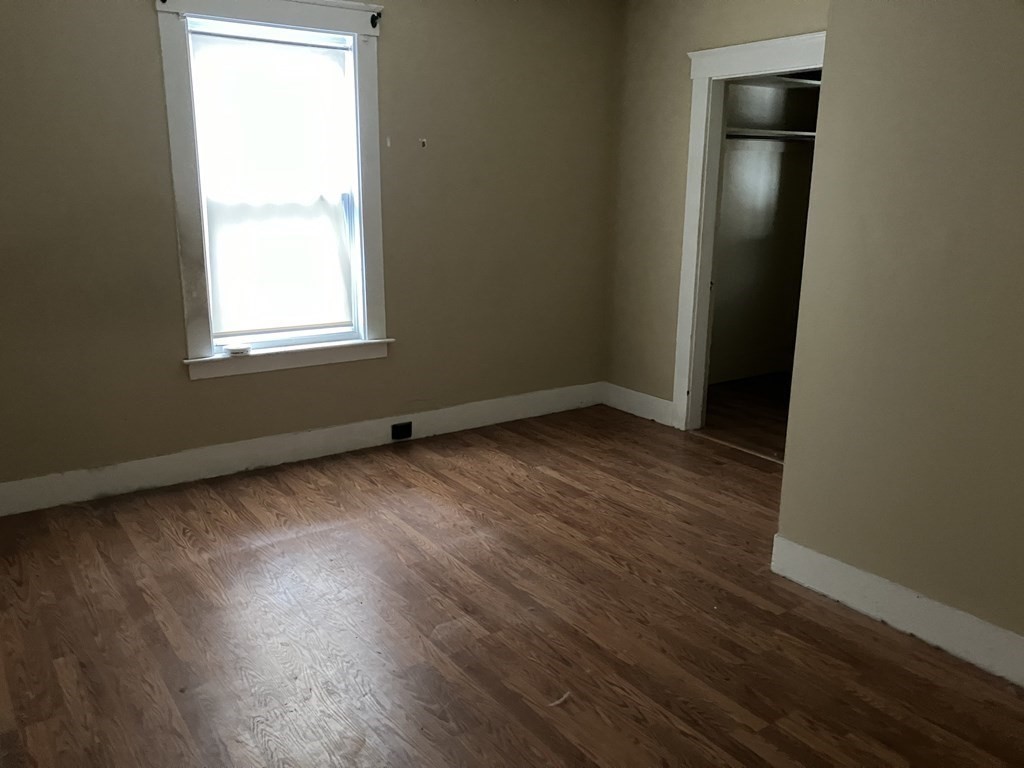 328 Worcester Street Southbridge, MA 01550 - Photo 13 of 26 an empty room with wooden floor and windows