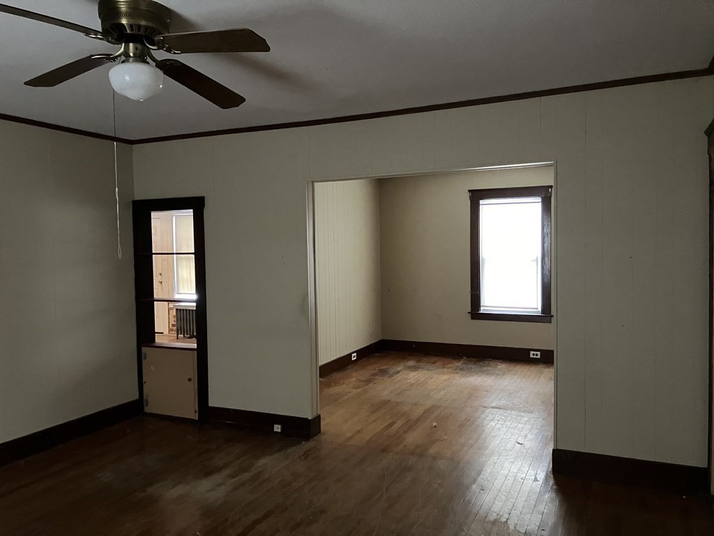 328 Worcester Street Southbridge, MA 01550 - Photo 14 of 26 a view of an empty room with a window and wooden floor