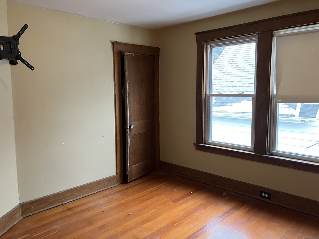 328 Worcester Street Southbridge, MA 01550 - Photo 16 of 26 an empty room with wooden floor and windows