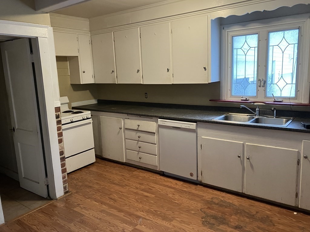 328 Worcester Street Southbridge, MA 01550 - Photo 5 of 26 a kitchen with granite countertop white cabinets and white appliances