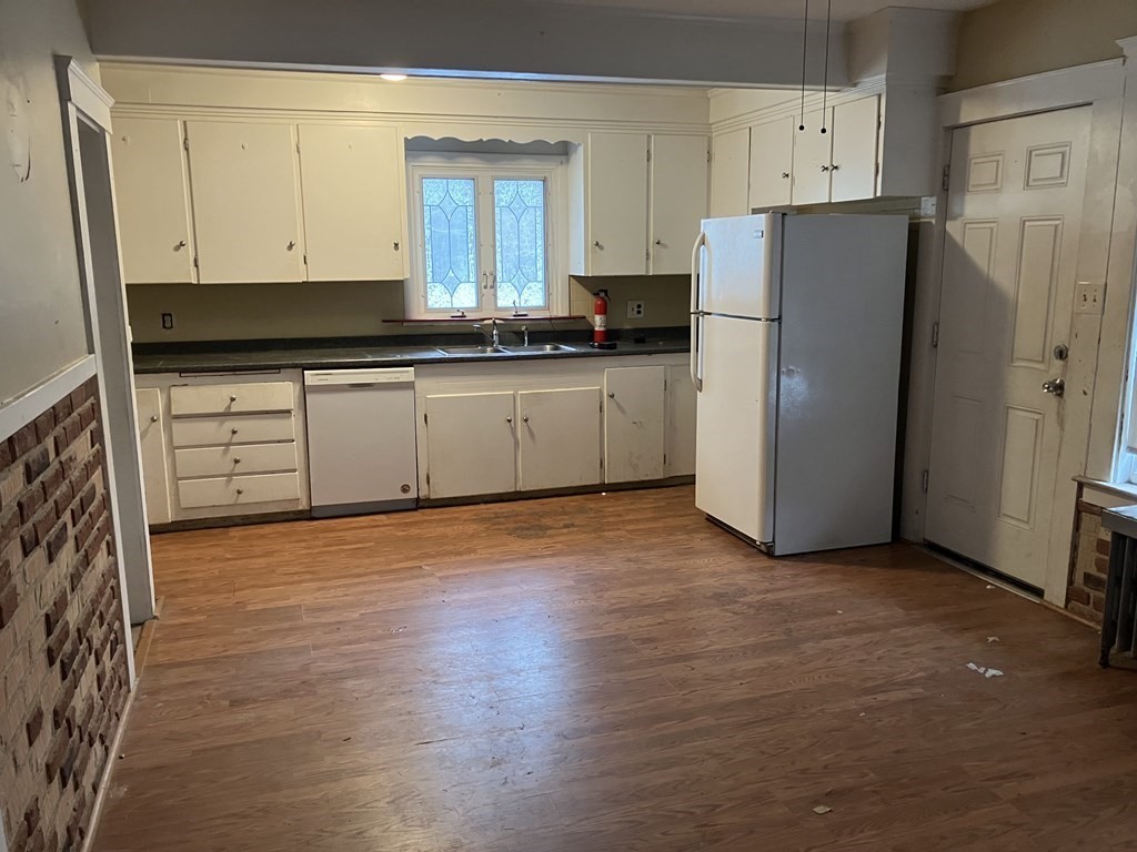 328 Worcester Street Southbridge, MA 01550 - Photo 8 of 26 a kitchen with a refrigerator and white cabinets