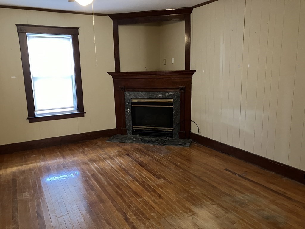 328 Worcester Street Southbridge, MA 01550 - Photo 10 of 26 a view of an empty room with wooden floor and a window