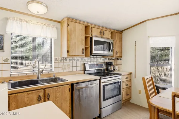 a dining room with furniture a chandelier and fireplace