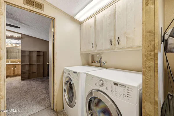 a view of a dining room with furniture large window and stainless steel appliances